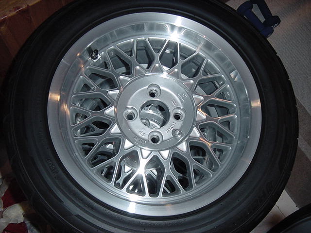 BMW alloy wheel with tire, showing intricate spoke design and tire sidewall