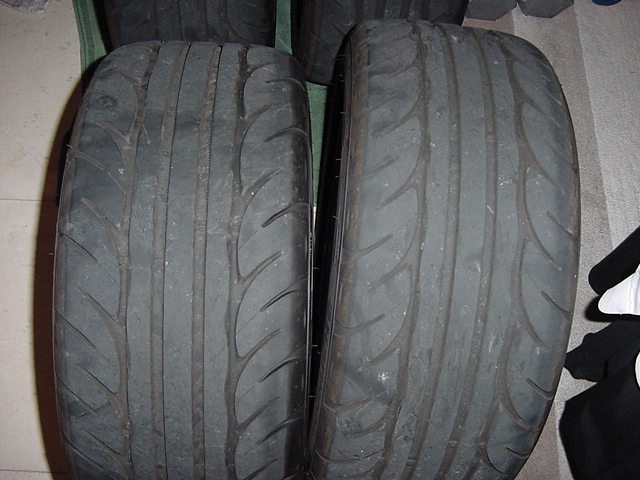 Two used performance tires, close-up view