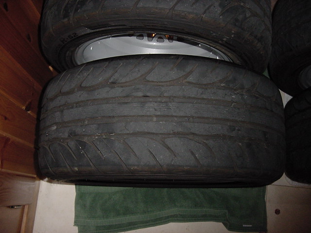 Stack of performance tires with one wheel visible