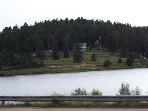 1972 Ford Ranchero - A scenic view of houses among trees on a hill overlooking a body of water.