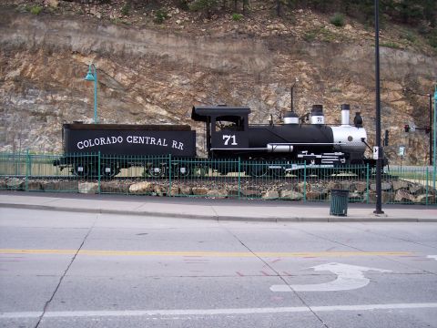 1972 Ford Ranchero - Colorado Central Railroad engine number 71 and its tender sit on display near a rocky hillside.