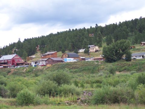 1972 Ford Ranchero - A view of a small town on a forested hillside, with various buildings and vegetation visible.