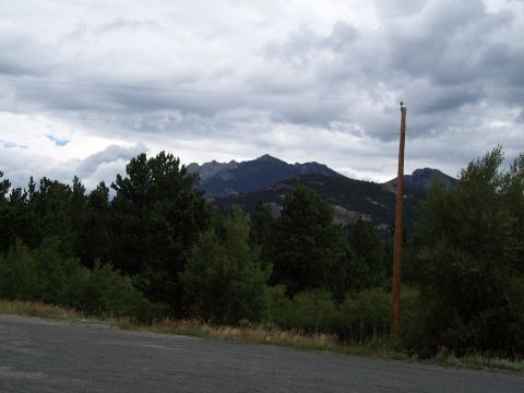 1972 Ford Ranchero - A scenic view of mountains and trees under a dramatic cloudy sky.