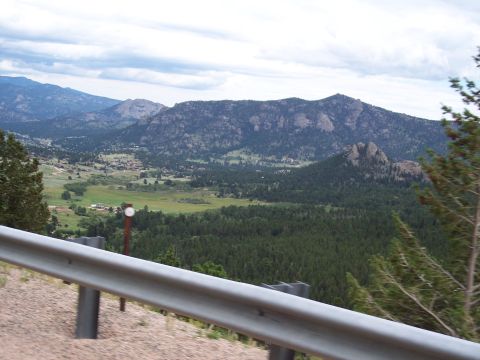 1972 Ford Ranchero - Expansive mountain valley scenery under a cloudy sky, with a guardrail in the foreground.