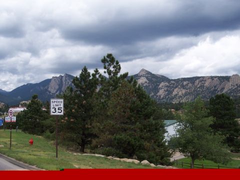 1972 Ford Ranchero - A scenic view of mountains under a cloudy sky, with a speed limit sign indicating 35 mph.
