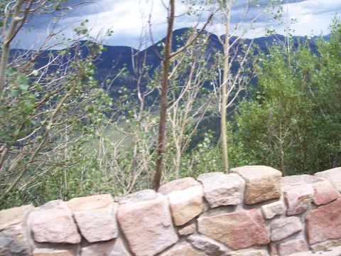 1972 Ford Ranchero - A scenic view of mountains and trees, framed by a stone wall.