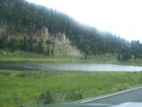 1972 Ford Ranchero - A scenic view of a lake surrounded by a dense forest and rocky hills.