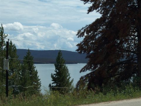 1972 Ford Ranchero - A scenic view of a lake surrounded by trees under a partly cloudy sky.
