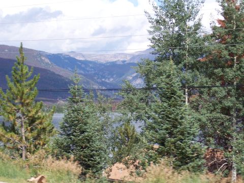 1972 Ford Ranchero - A scenic view of mountains, a lake, and trees under a cloudy sky.
