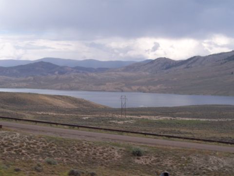 1972 Ford Ranchero - A wide view of a lake surrounded by rolling hills and mountains under a cloudy sky.