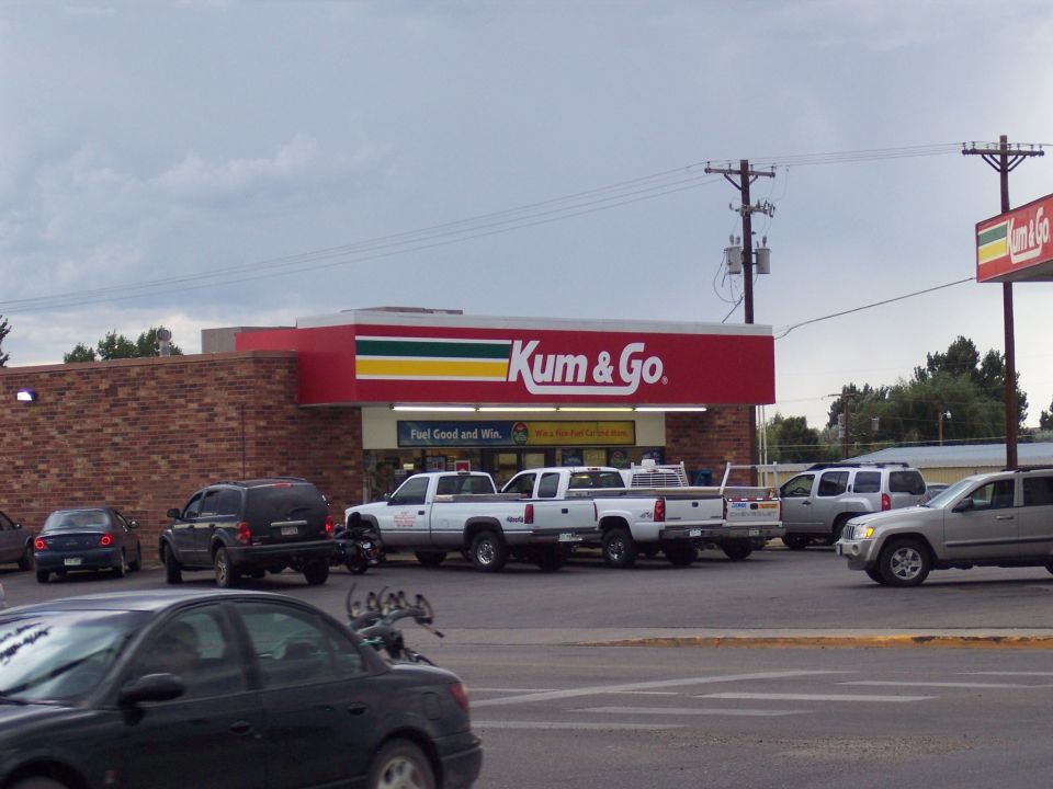 Parking lot at a Kum & Go store with pickups, SUVs and cars parked out front.