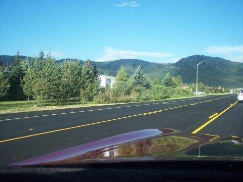 1972 Ford Ranchero - View from inside a vehicle driving on a highway with mountains in the distance.