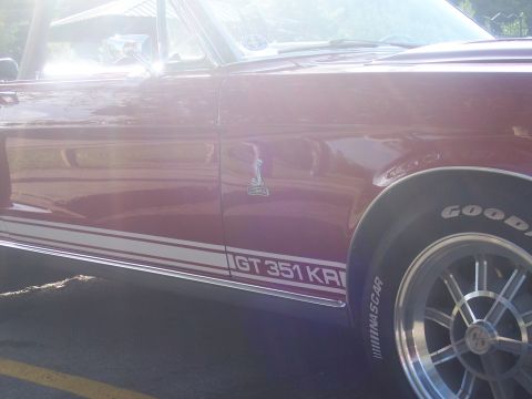 1972 Ford Ranchero - Side view of a red convertible a GT 351 KRI stripe and a Cobra emblem, likely a 1968 model.