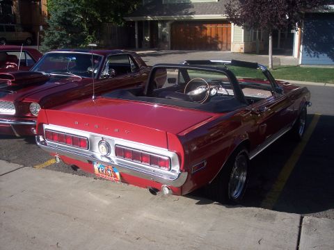 1972 Ford Ranchero - Two red classic cars, a 1968 Mustang convertible and another Ford, parked in a driveway.