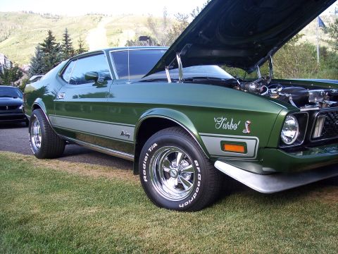 1972 Ford Ranchero - A green 1971-1973 Ford Mustang coupe with the hood open, 'Turbo' badging and a silver stripe along the side.