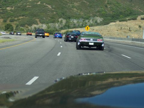 1972 Ford Ranchero - A green 1971 Ford Mustang Mach 1 is seen driving on the highway with other vehicles.
