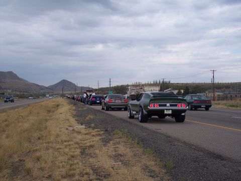 1972 Ford Ranchero - A line of cars, including a green 1969 Ford Mustang Mach 1, are stopped on the side of a highway.