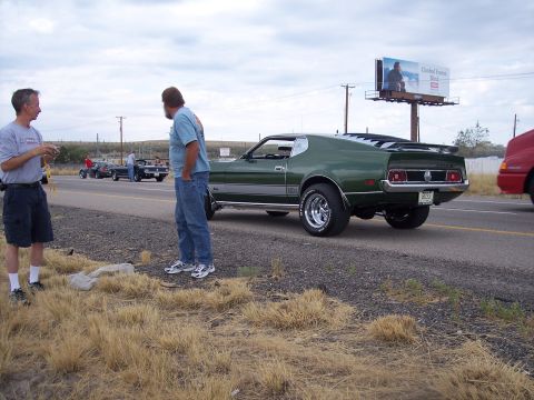 1972 Ford Ranchero - A green 1971 Ford Mustang Mach 1 is parked roadside with two men standing nearby.
