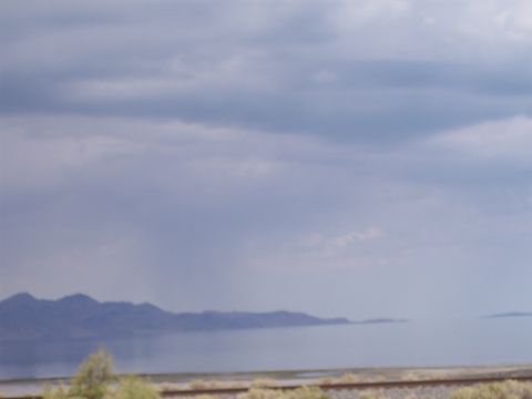 1972 Ford Ranchero - A wide view of a landscape mountains, water, and railroad tracks under a cloudy sky.