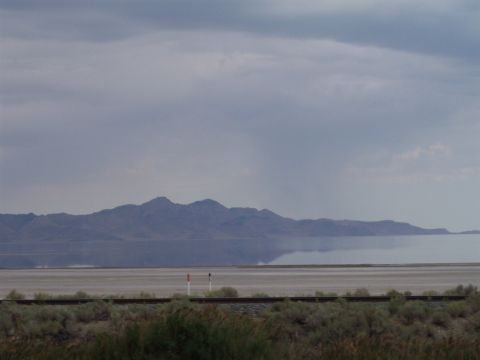 1972 Ford Ranchero - A vast desert landscape unfolds with distant mountains reflected in a body of water under a dramatic sky.