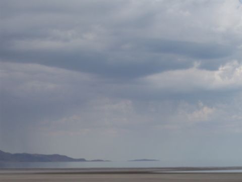 1972 Ford Ranchero - A vast, cloudy sky looms over a desolate landscape with mountains in the distance.