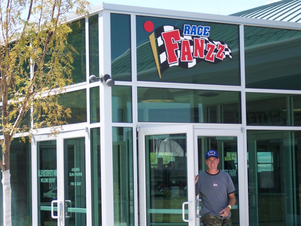 Man standing at glass entrance of Race Fanzz building
