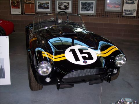 1972 Ford Ranchero - A classic black race car with prominent yellow stripes and the number 15 is displayed indoors.