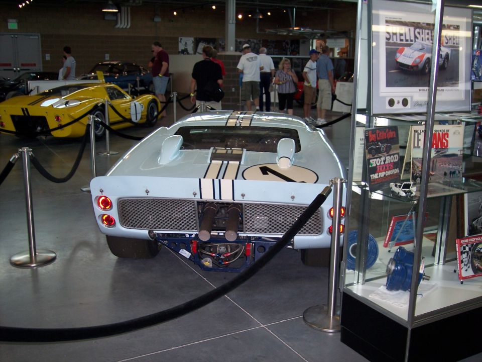 Rear of light blue striped race coupe on museum display