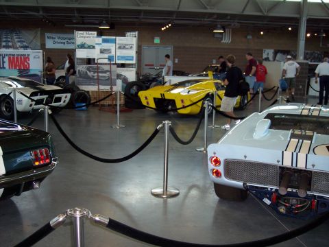 1972 Ford Ranchero - A collection of Ford GT40 race cars are displayed indoors, separated by velvet ropes.