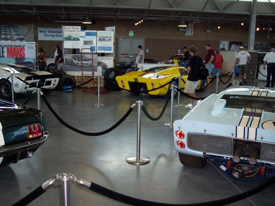 Museum display of vintage Ford GT40 race cars behind rope barriers