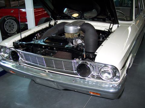 1972 Ford Ranchero - Front view of a 1964 Ford Falcon's engine bay, showing the V8 engine and chrome grille.