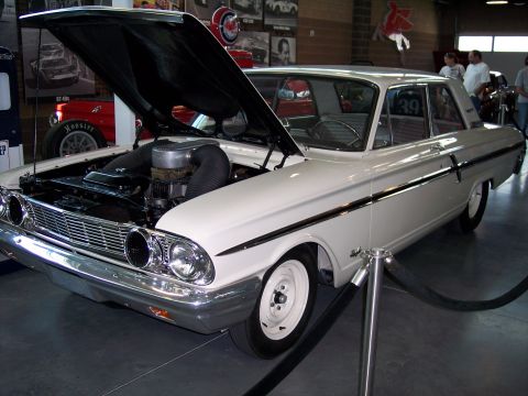 1972 Ford Ranchero - A white 1961 Ford Falcon is displayed with its hood open, revealing the engine compartment.
