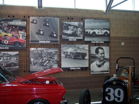 1972 Ford Ranchero - A museum exhibit features historical racing photos and a vintage red car.