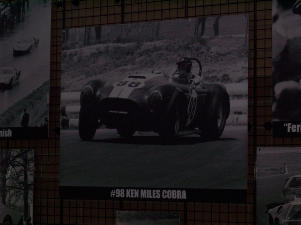 Framed B&W photo of vintage #98 Cobra race car with driver, captioned 'Ken Miles Cobra'