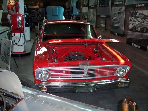 1972 Ford Ranchero - Front view of a red 1964 Ford Falcon in a museum setting, engine exposed.