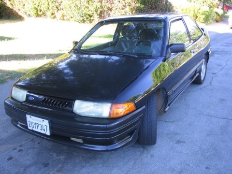 1989 Ford Bronco - This black hatchback has a Ford logo on its grille and a California license plate.