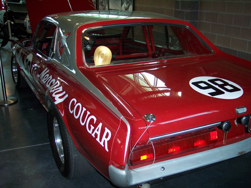 Red Mercury Cougar race car, rear 3/4 view, number 98 and roll cage