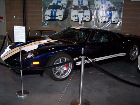 1972 Ford Ranchero - A dark blue Ford GT sports car with white racing stripes is displayed indoors.