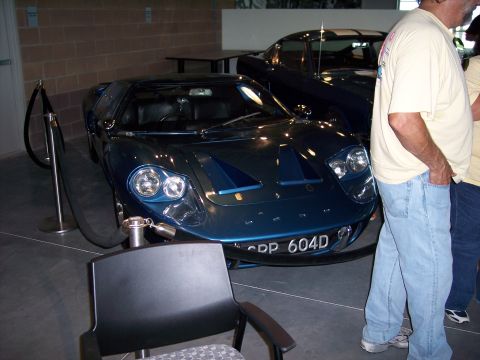 1972 Ford Ranchero - A blue Ford GT40 is displayed indoors next to another dark blue car.