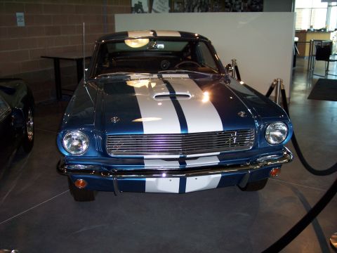 1972 Ford Ranchero - A classic blue coupe with prominent white racing stripes is displayed indoors.