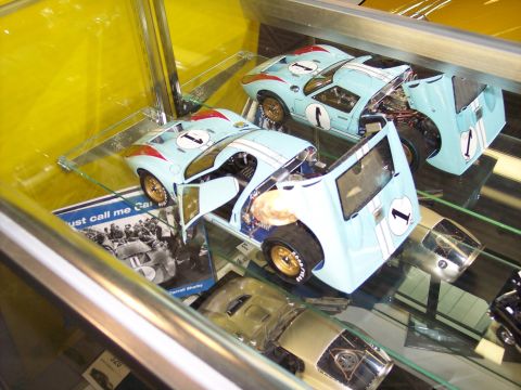 1972 Ford Ranchero - Several model cars are displayed in a glass case, some with their hoods and doors open, revealing intricate details.