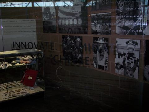 1972 Ford Ranchero - A display case holds model cars, while historical photographs adorn the brick wall behind it.