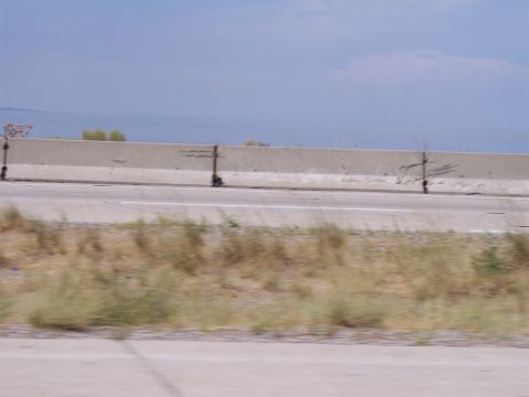 1972 Ford Ranchero - A view of a highway with a concrete barrier and dry grass, suggesting a roadside scene.