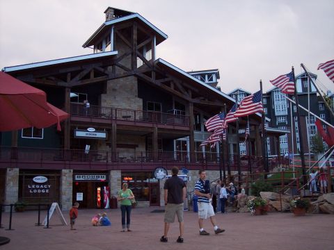 1972 Ford Ranchero - A building with multiple levels and balconies is adorned with American flags, with people gathered in the plaza below.