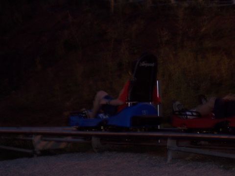 1972 Ford Ranchero - Alpine coaster carts travel along a track at night, carrying passengers through the dark.