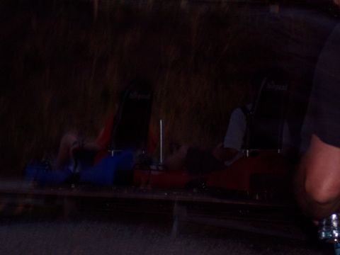 1972 Ford Ranchero - Two individuals are seated in a ride vehicle, with dark surroundings and blurred motion.