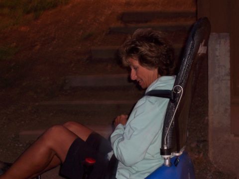 1972 Ford Ranchero - Woman seated in a harness, possibly on a ride or in a specialized chair.