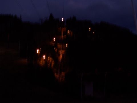 1972 Ford Ranchero - Nighttime view of a ski slope with lights on the slope and trees in the background.