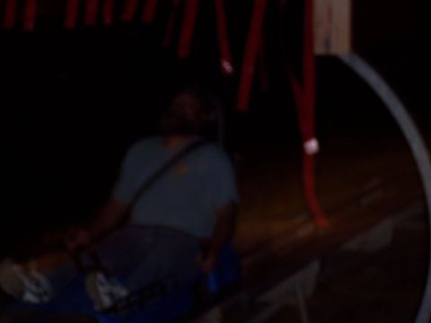 1972 Ford Ranchero - A person is seated inside a vehicle, with red streamers visible above in the darkness.