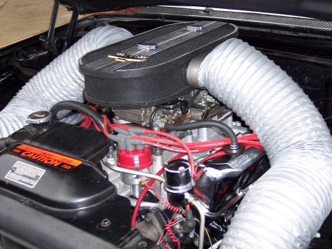 1972 Ford Ranchero - Close-up of a car's engine bay, a custom air intake system with flexible silver hoses.